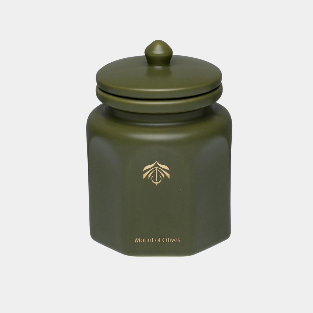 An olive green hexagonal ceramic candle vessel with a matching lid, featuring a gold logo and the text 'Mount of Olives' on the front, set against a light gray background.